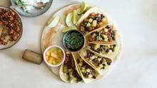 Plant based tacos on a round plate.