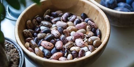 A wooden bowl full of dried beans of different varities