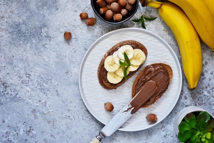 Chocolate spread on toast topped with banana.