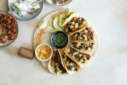 Plant based tacos on a round plate.